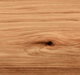 Close-up of TruLog steel log siding with natural wood grain texture.