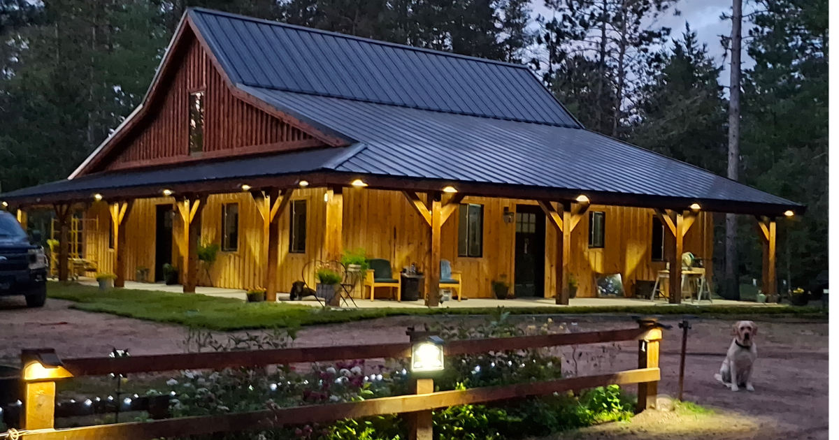 Black standing seam metal roof installed on a new construction home in Hayward, WI by Precise Exteriors.