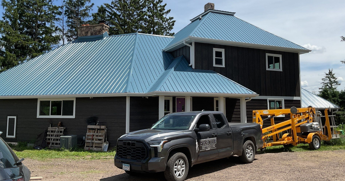 Exterior remodeling project in Hillsdale, WI featuring LP SmartSide siding, Walsh windows, a new door, gutters, and downspouts.